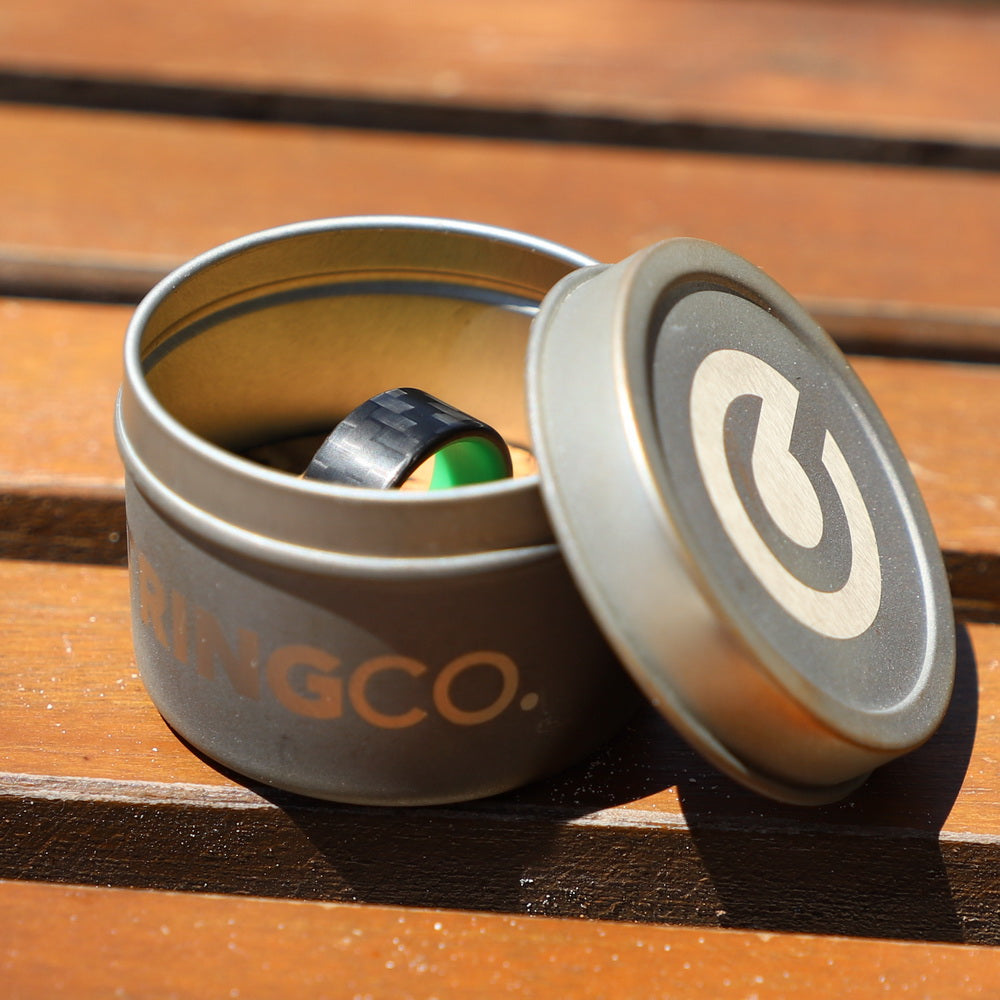Carbon Fiber Green Glow Ring In Its Container